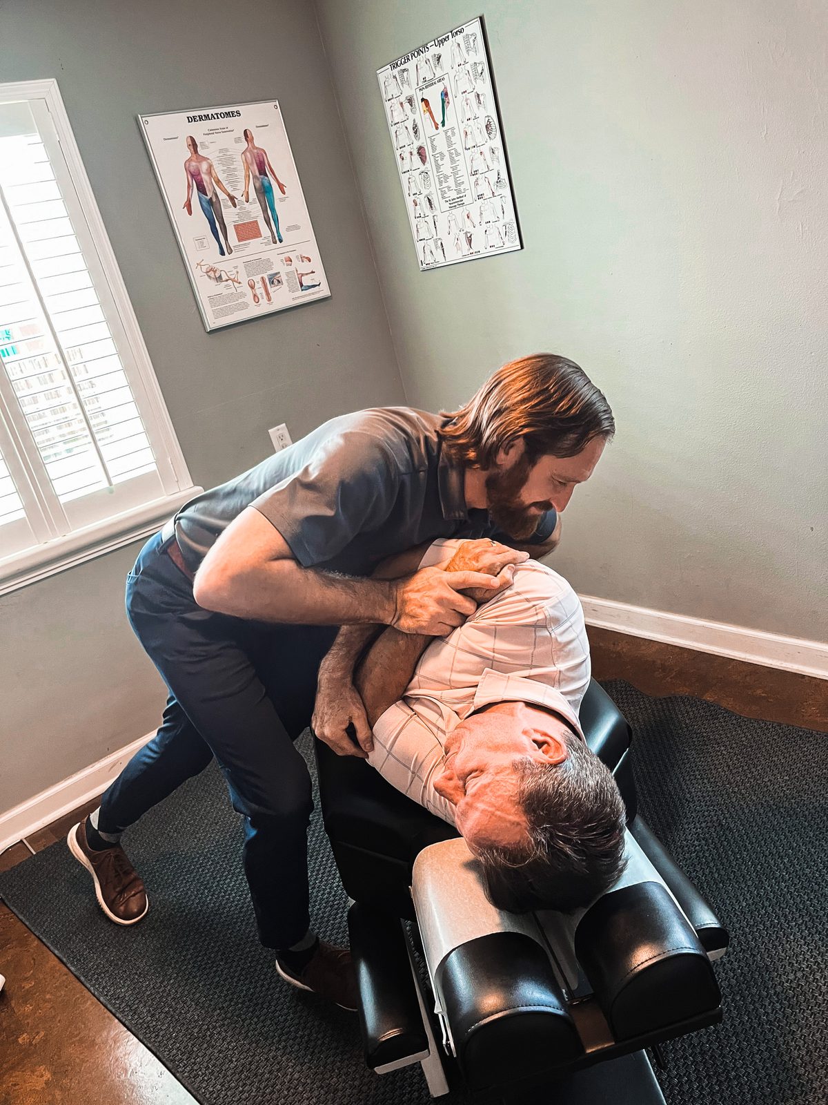 Dr. Jeff Bourguignon performing a spinal adjustment in the Henderson Blvd clinic
