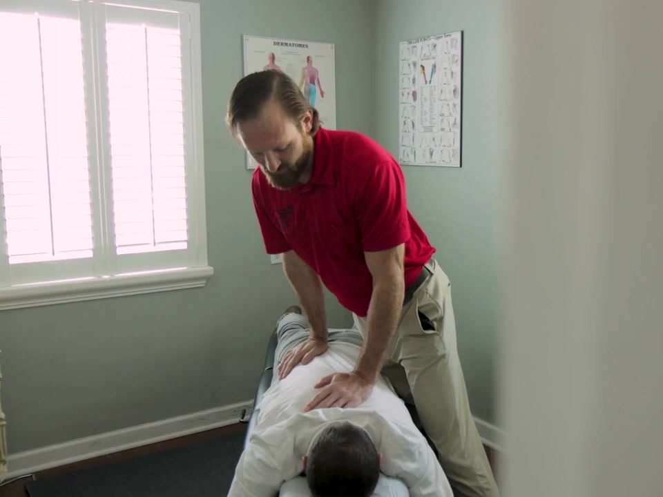 Dr. Jeff adjusting a patient in the treatment room